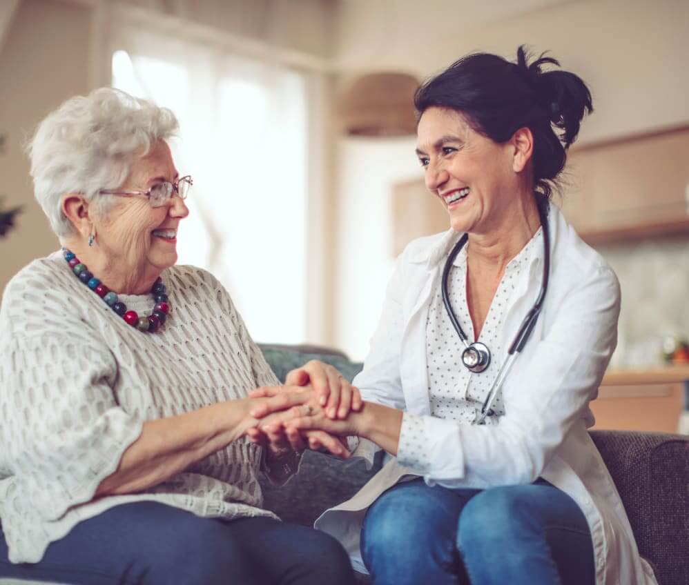 Senior woman receiving compassionate support from a caregiver at Village on the Park Bentonville Assisted Living Community